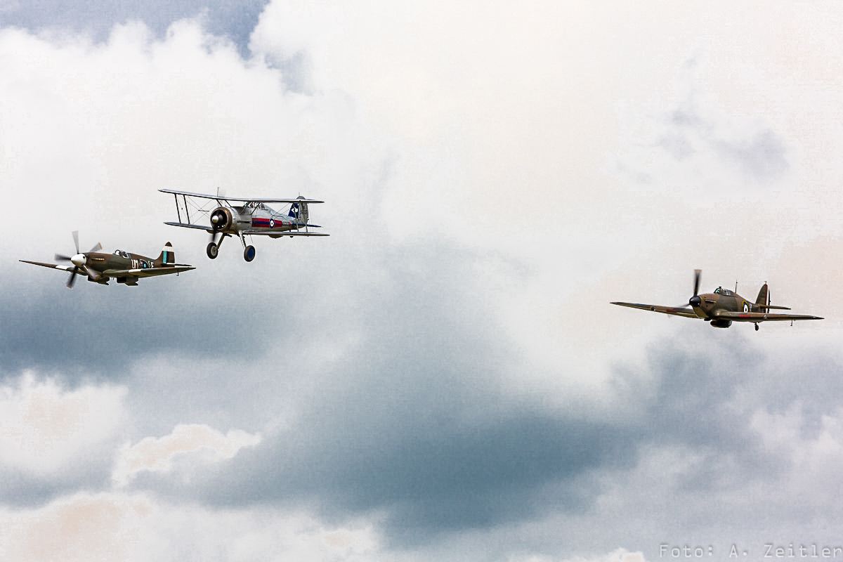 La Ferté-Alais 2015 - Air Show Report 19 A Gloster Gladiator in formation with a Battle of France-veteran Hawker Hurricane and a Supermarine Spitfire.