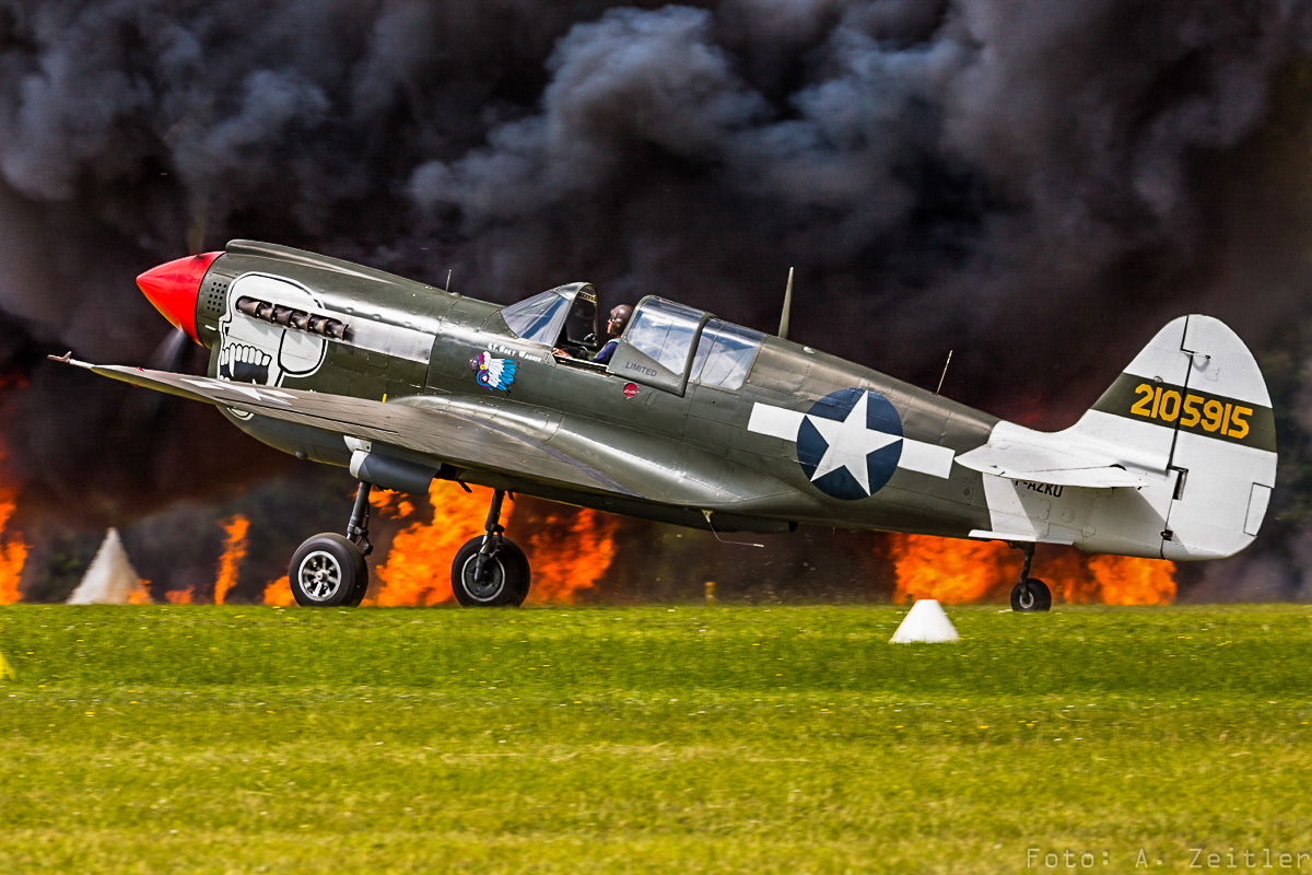 La Ferté-Alais 2015 - Air Show Report 20 The P-40 under attack in the Pearl Harbor routine.