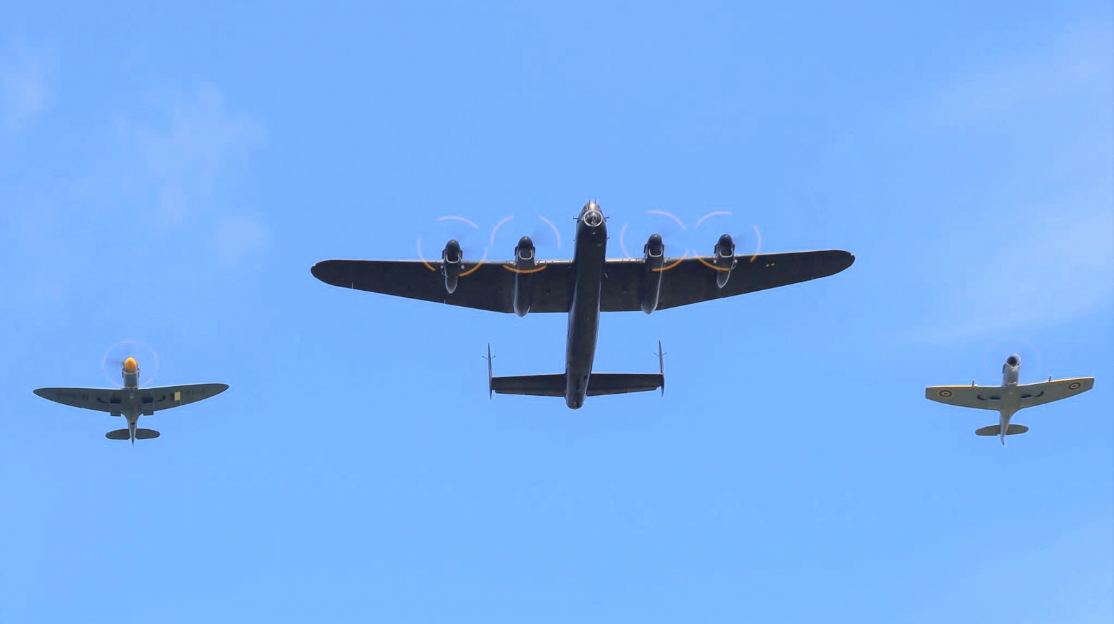 The Battle of Britain Memorial Flight Hosts 2025 Members’ Day at RAF Coningsby 13 Lancaster PA474 and Spitfires TE311 and PM631 arrive over the crowd on Members Day 2025. Photo Keith Chadwick