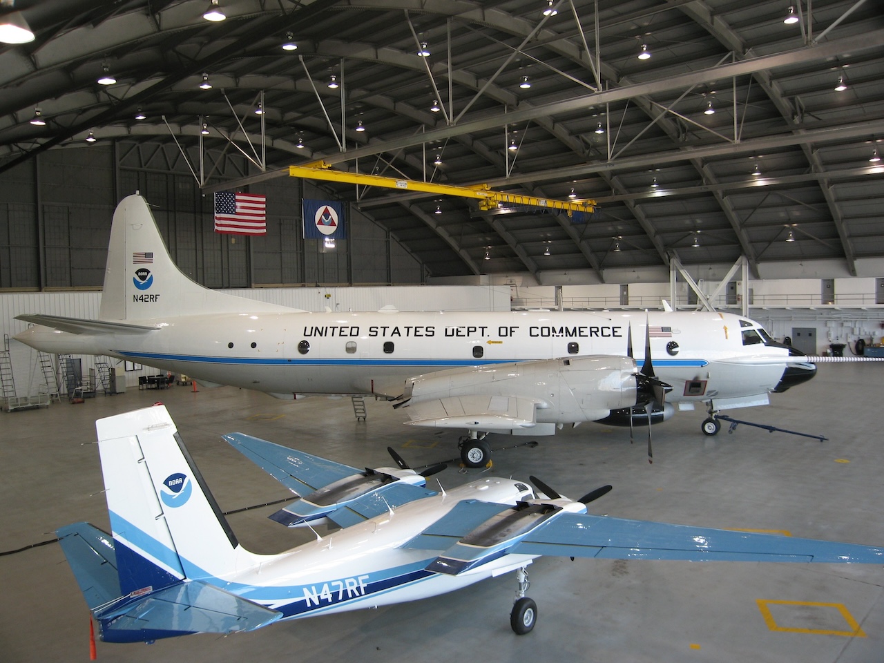 The History of The Hurricane Hunters 17 Lockheed WP 3D Orion N42RF and Rockwell Aero Commander AC 500S N47RFin hangar at MacDill Air Force Base