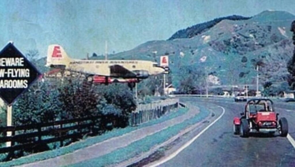 A Stroke of Marketing Genius: Local Businesses, Vintage Aircraft, And Their Unusual Association 28 Mangawekas DC 3 quickly became a famous landmark featured in magazines and postcards such as this one that warns of low flying tearooms. SUPPLIED NOT FOR SYNDICATION
