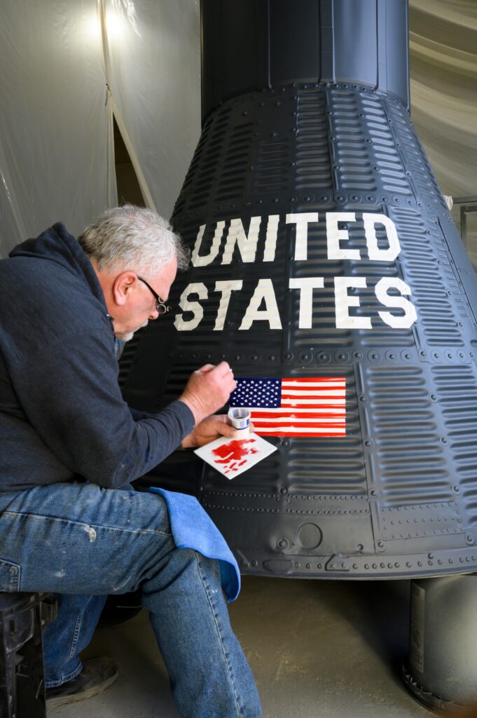 National Museum of the USAF Erects Atlas Missile 20 Mercury Capsule being painted
