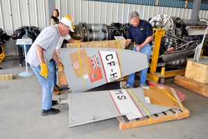 The Long and Winding Road of the City of Calgary's Mosquito Finally Leads to a Restoration 23 Volunteers sorting through the pieces of the Mosquito in Nanton (Image Credit: Calgary Mosquito Society)