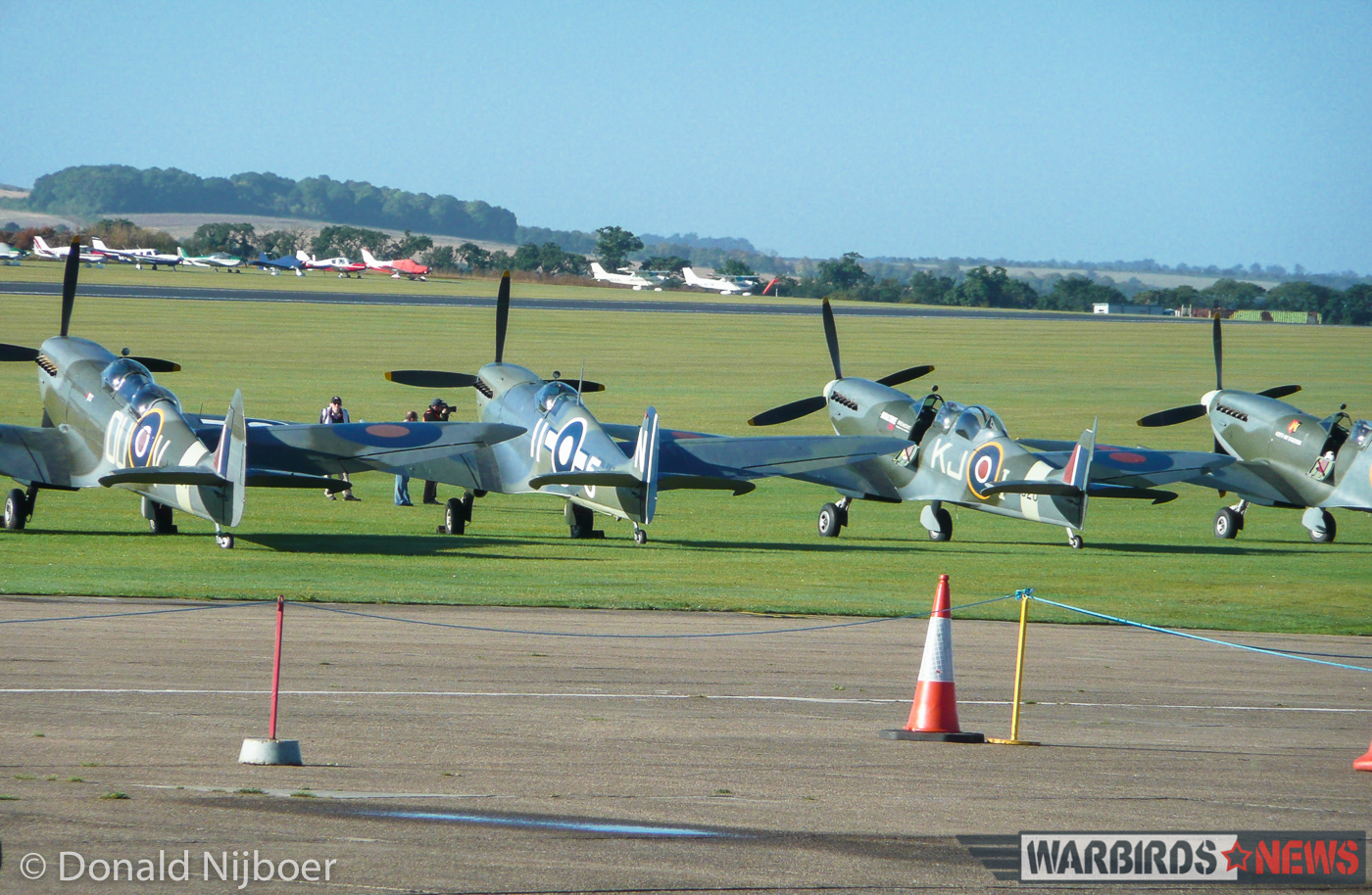 Duxford - Meet the Fighter Air Show 14 Four of the fourteen Spitfire variants which took part in the massed flypast near the end of the show. Here we see, from the left, a pair of Spitfire Tr.9 two seat trainers flanking a rare Seafire LF.III. Spitfire Mk.IX RR232 'City of Exeter' sits at the far right. (photo by Donald Nijboer)