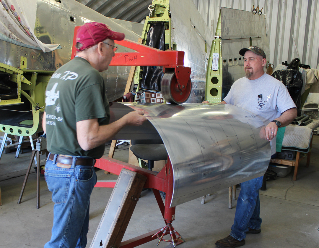 XP-82 Twin Mustang - February 2016 - Restoration Update 11 Paul and Randall hand forming the nose cowling skins using an English Wheel. (photo via Tom Reilly)