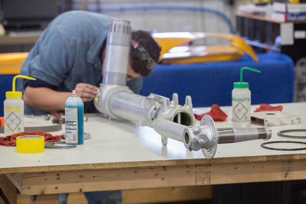 Texas Flying Legends P-51C Restoration Report 38 Clyde works on the pivot end of the main gear. (photo via AirCorps Aviation)
