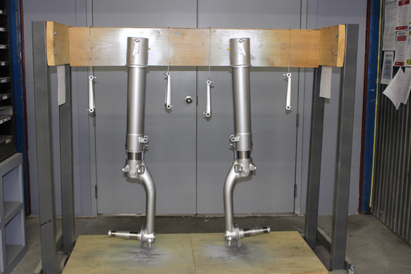 Texas Flying Legends P-51C Restoration Report 41 Both gear and the scissors linkages, shown just after painting, hang on a rack in the restoration shop. (photo via AirCorps Aviation)