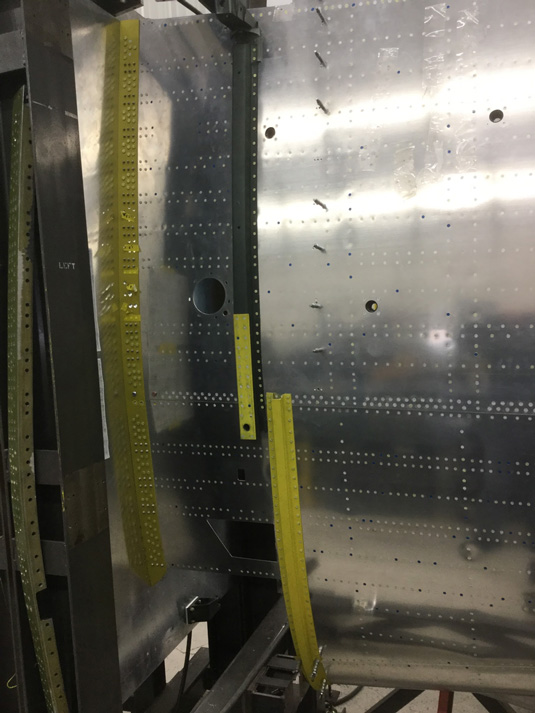 Texas Flying Legends P-51C Restoration Report 46 The guys are installing the wing fairing nutplates, and the wing attach angles are about 95% installed. (photo via AirCorps Aviation)