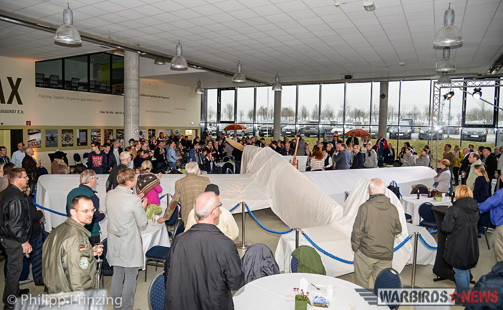 Freshly Restored Bücker Bü 180 Student Unveiled in Germany 10 Under a white sheet prior to her unveiling, the Student sits inside the Quax flying club's hangar during their 10th anniversary celebrations. (photo by Philipp Prinzing)