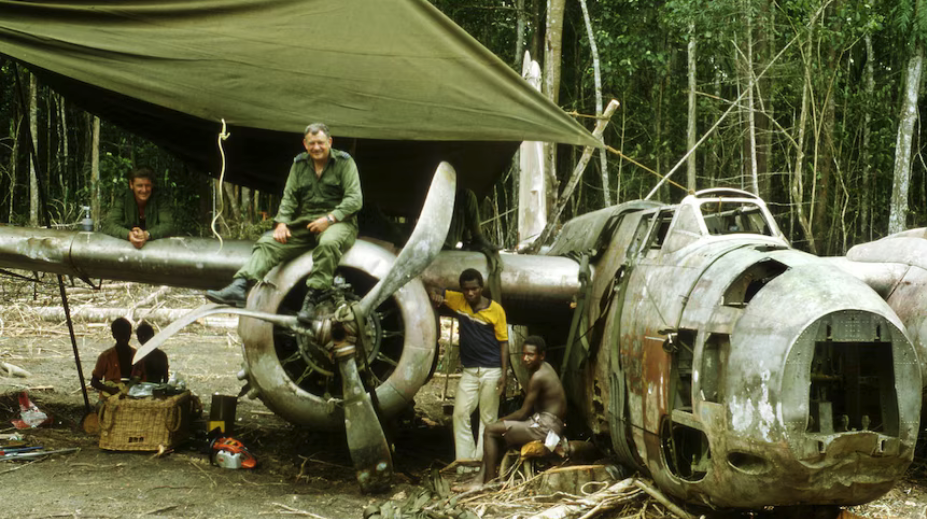 WWII Bomber Douglas A-20 Havoc Returns to Papua New Guinea After 80 Years 12 RAAF Wing Commander Tom Kelly poses on the engine of the Helln Pelican II Douglas A 20G Havoc bomber during its salvage operation in October 1984. Photo courtesy of Michael Claringbould