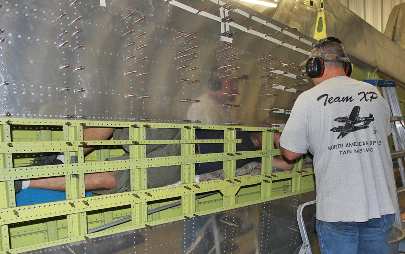XP-82 Twin Mustang - September 2015 - Restoration Update 11 Randall and Aymen working on the wing... note how one of the men is actually inside the wing bucking the rivets. (photo via Tom Reilly)