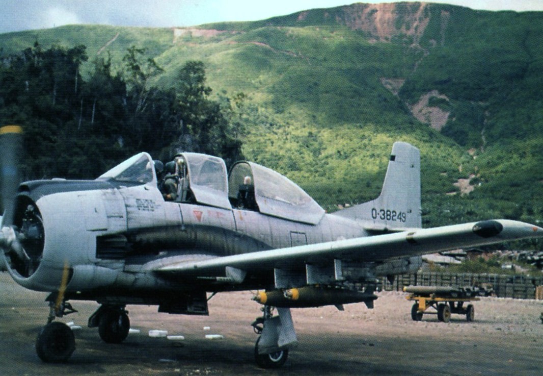 Combat Veteran T-28D Trojan Returning to Flight Downunder 12 An example of a T-28D Nomad in Royal Laotian Air Force markings seen at Long Tieng airfield in Laos in September, 1972. (photo by Hugh Tovar via Wikipedia)
