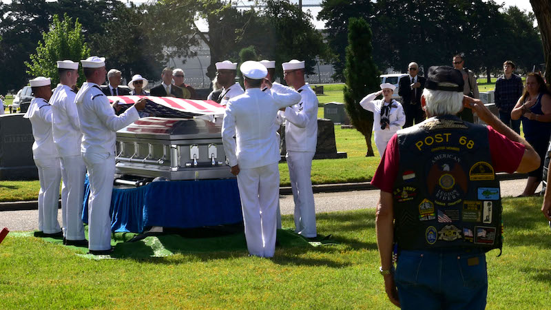 Air Force Salutes ‘Flying Tiger’ After 75 Year Journey Home 12 Service members, family members and other guests pay respects while Taps plays during the funeral of John Dean Armstrong, a member of the Flying Tigers, June 17, 2017, in Hutchinson, Kan. Armstrong returned home 75 years after his death in a training accident in Burma. (U.S. Air Force photo/Staff Sgt. Trevor Rhynes)