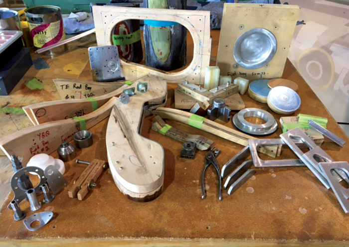 Vintage Wings of Canada's Spitfire Update 15 The multi-dimensional complexities of building a Spitfire in the Castle Bromwich factory during the Second World War were overcome by jigs, custom tools, forms, molds, templates and thousands of employees. To build Spitfire wings, controls and fuselage components in Canada in the Third Millennium—70 years after the factories were closed—took some ingenuity on the part of Wood. In many cases he needed to first build tools that would enable him to build the parts or to form three-dimensional magic in metal—tools like the “Fuel Bay Sumptuator”, “Wing-Rib Former 2000 Max”, “Fairey Fastener Locator”, and the world-famous “Bearing Dust Seal Flangetron” (patents pending). (Photo by Ken Wood)