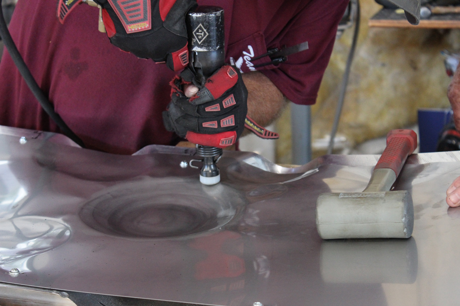 XP-82 Twin Mustang - October, 2017 - Restoration Update 22 Larger strokes are made using the rubber mallet to bash the sheet metal into the die form beneath, whereas finer manipulation is achieved using a rubber-tipped set on the rivet gun as shown in this closeup. (photo via Tom Reilly)