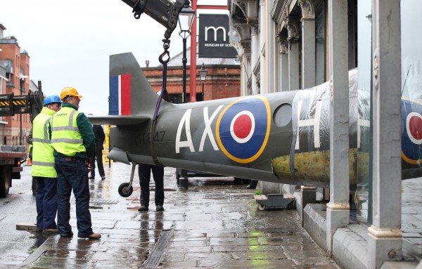 Spitfire FR.XIVe for RAF Museum Aerial Photography Exhibition 11 Technicians gently ease the fuselage of Spitfire FR.XIVe MT847 out of the Museum of Science and Industry in Manchester, England on February 9th. (photo by Chris Foster, via RAF Museum)