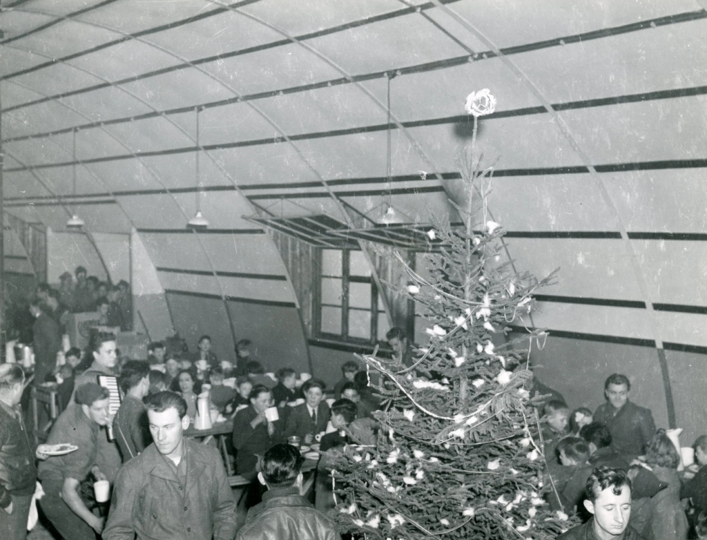 Christmas With The Mighty Eighth 13 The Christmas tree adds a festive note to the party given for British children by men of the 401st Bomb Group