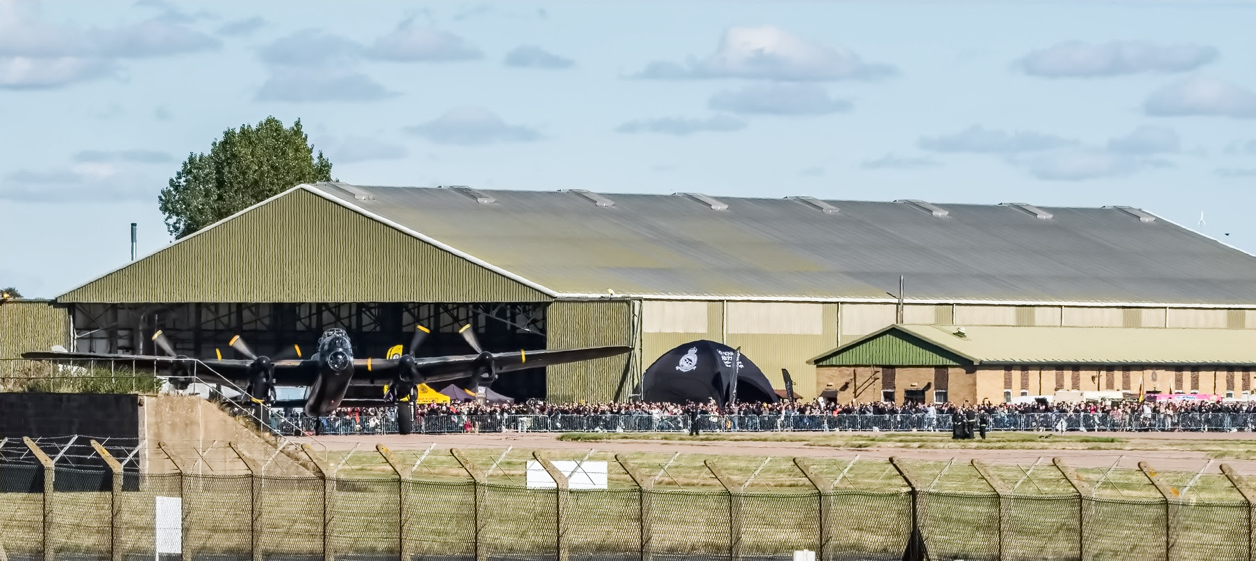Battle of Britain Memorial Flight Members’ Day Set for September 27 at RAF Coningsby 11 The view of the Members Day 2024 crowd from outside the fence for those not lucky enough to be inside. Photo Myles Radford