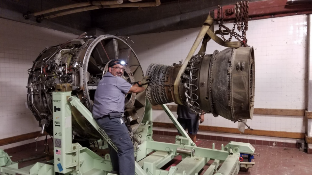 US Airways Flight 1549, Left Engine 11 US Airways mechanic Paul Sullivan works to reattach the compressor and turbine section of the left engine to the fan frame