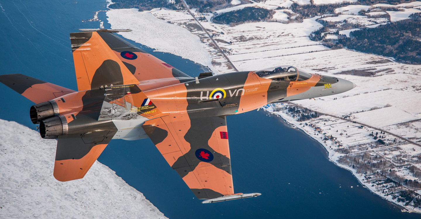 Battle of Britain - RAF/RCAF 75th Anniversary Schemes 15 The 2015 CF-18 Hornet Demonstration Aircraft flies over the Saguenay River on April 1st, 2015 near 3 Wing Bagotville, Saguenay, Qué. (Image: Canadian Armed Forces - LS Alex Roy, Atelier d'imagerie Bagotville.)
