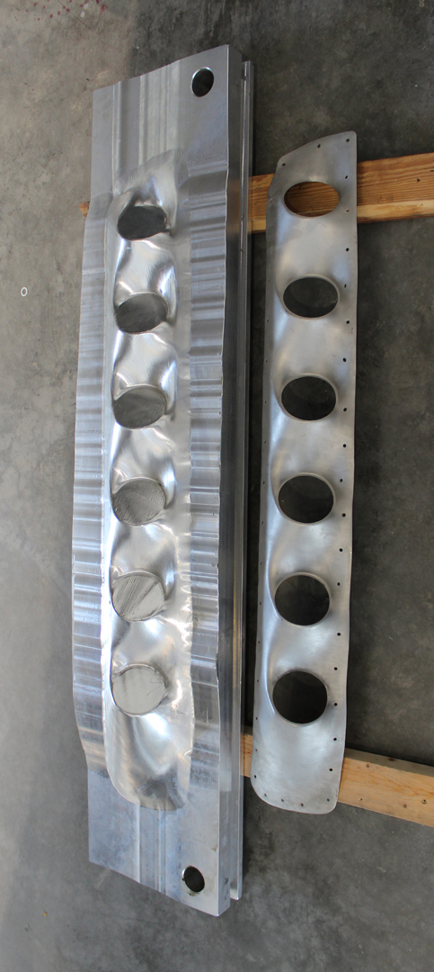 XP-82 Twin Mustang - October, 2017 - Restoration Update 25 The female die for the engine exhaust fairing alongside the finished article. Tom and his team will use a 200 ton hydraulic press to form these .050" stainless steel fairings between the male and female dies. (photo via Tom Reilly)