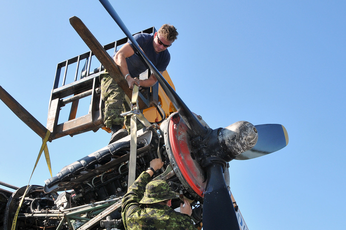 Lancaster KB882 Safely At Her New Home 18 RCAF technicians prepare an engine to be lifted from KB882. (Photo by Warrant Officer Fran Gaudet DND)