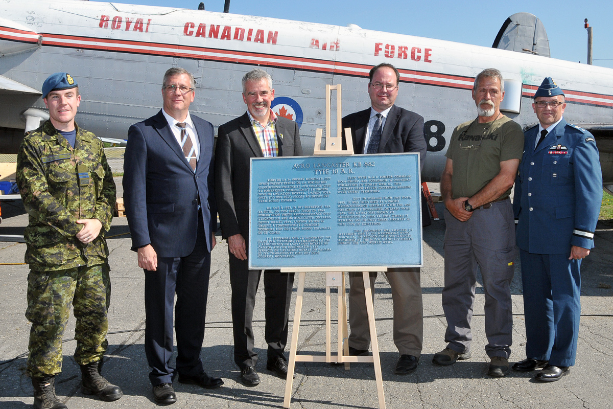 Lancaster KB882 Safely At Her New Home 13 Gathered around the plaque presented by the Edmundston mayor to the National Air Force Museum are (from left) Captain Jamie Boudreau of ATESS, heading the team dismantling KB882; Kevin Windsor, museum curator; Mayor Cyrille Simard; Dr. Richard Mayne, the RCAF’s chief historian; Mike Joly, head of the restoration shop at the museum; and Brigadier-General Scott Howden of the RCAF. (Photo by Warrant Officer Fran Gaudet DND)