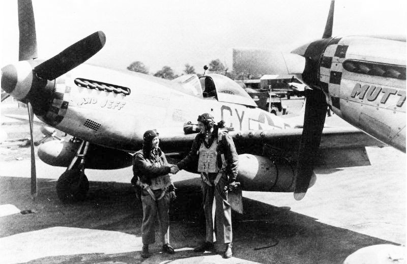 The Fighting Scouts of The Eight Air Force 13 Lt. Richard “Dick” Jacobson (L) and Capt. Edward Unger (R) both ex 486th Bomb Group, congratulate each other on being assigned to the 3rd Scouting Force. Unger was the pilot of the B-17 "Five Grand" (the 5,000th B-17 produced by Boeing) and Jacobson the co-pilot. They both finished their tours with the 486th at the same time and both volunteered for the Scouting Force. Due to the disparity in their heights, with Ed being 6' 4" and Dick 5' 6", they were known as "Mutt and Jeff" from the popular cartoon characters of the time and named their P-51s accordingly. Photo via NARA