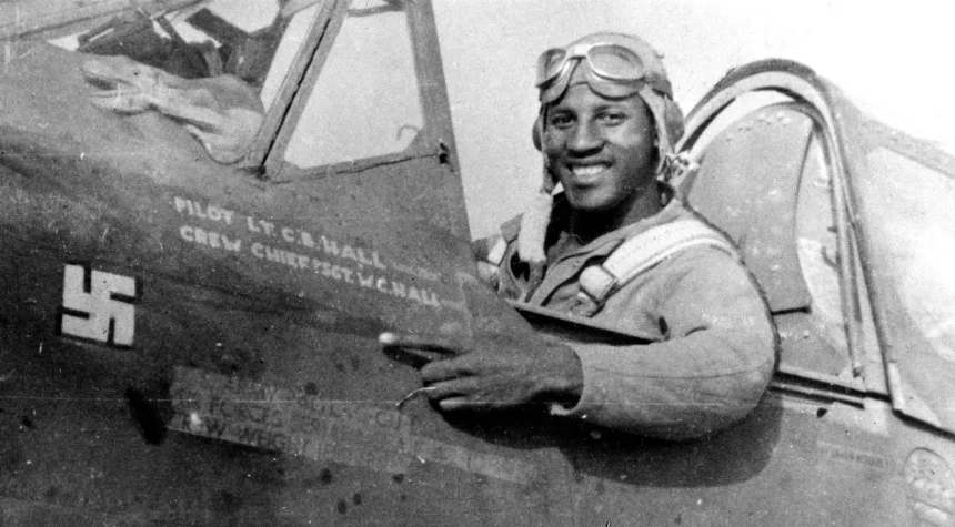 1st Lieutenant Charles B. Hall in the cockpit of his Curtiss Wright P 40L Warhawk