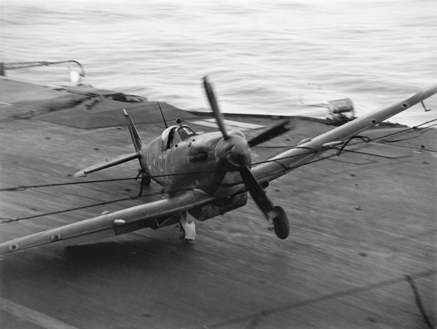 A Supermarine Seafire hits the barrier on HMS INDEFATIGABLE after returning from a strike on the Japanese oil refinery at Pangkalan Brandan Sumatra 1 April 1945. A27176