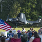 Flying Proms Symphonic Air Show Returns to The Military Aviation Museum 15 Douglas AD 4 Skyraider Salutes the Flag during the Flying Proms