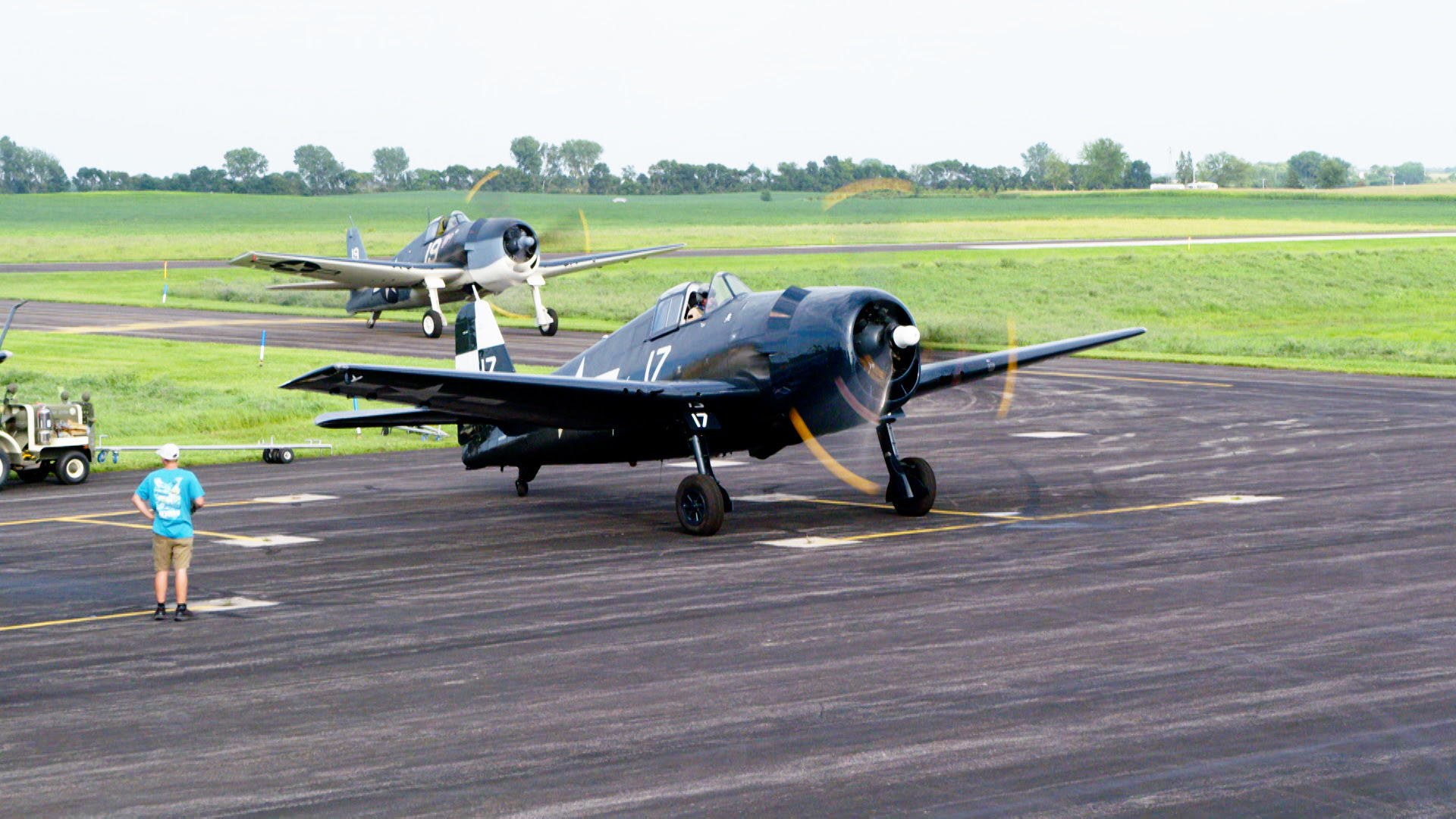 Fagen Fighters WWII Museum Victory at Sea 14 F6F 5N BuNo 94204 night fighter owned by the Erickson Aircraft Collection with Stevo in the background