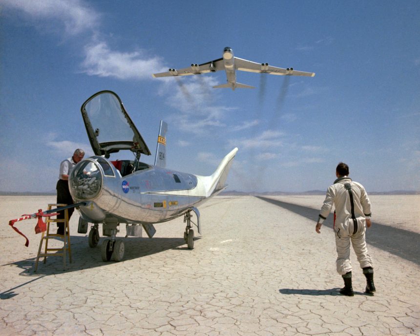 NASA research pilot Bill Dana takes a moment to watch NASA's NB-52B cruise overhead after a research flight in the HL-10.