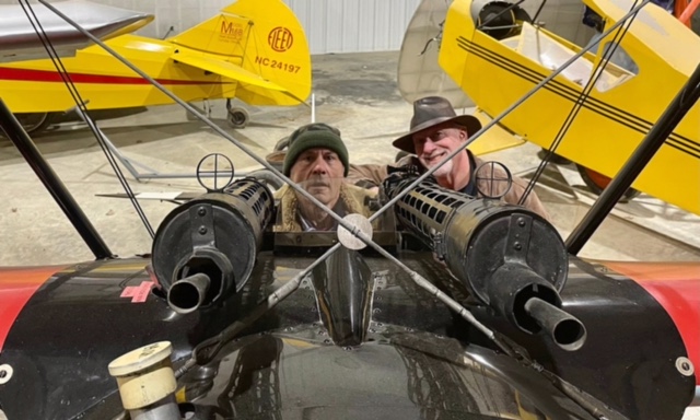 Iron Maiden's Bruce Dickinson in the Old Rhinebeck Fokker Dr.I replica compares notes with ORA pilot Dave King. [Photo via Old Rhinebeck Aerodrome]