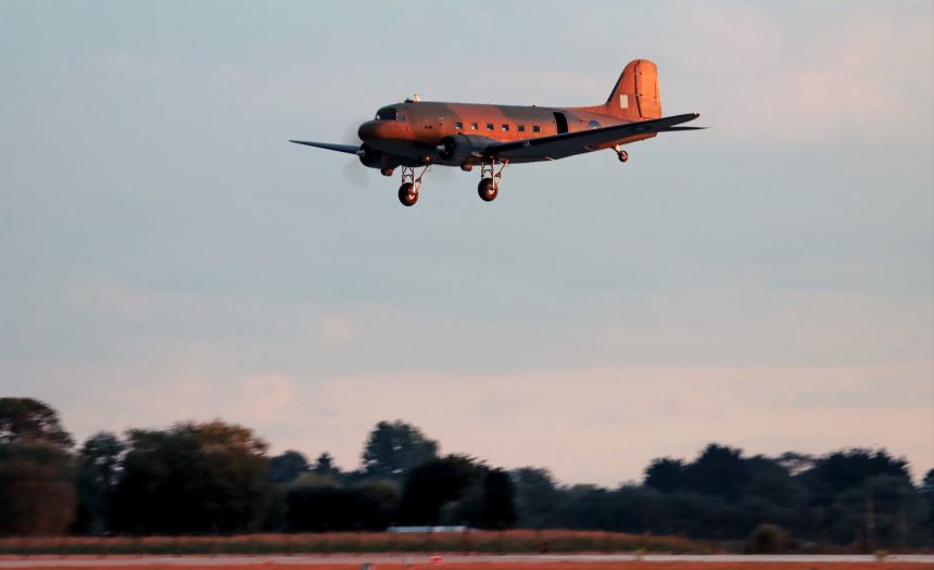 Lit by the early evening setting sun BBMF Dakota ZA947 makes an approach to land at RAF Coningsby on 29th August 2025 after over three years away. Photo Kiran Lear via BBMF