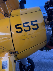 Locally known as Triple Nickel, Stearman N555BF now also carries a tribute to Randy "Doc" Sherman on both sides of the cowling. [Photo by Adam Estes]